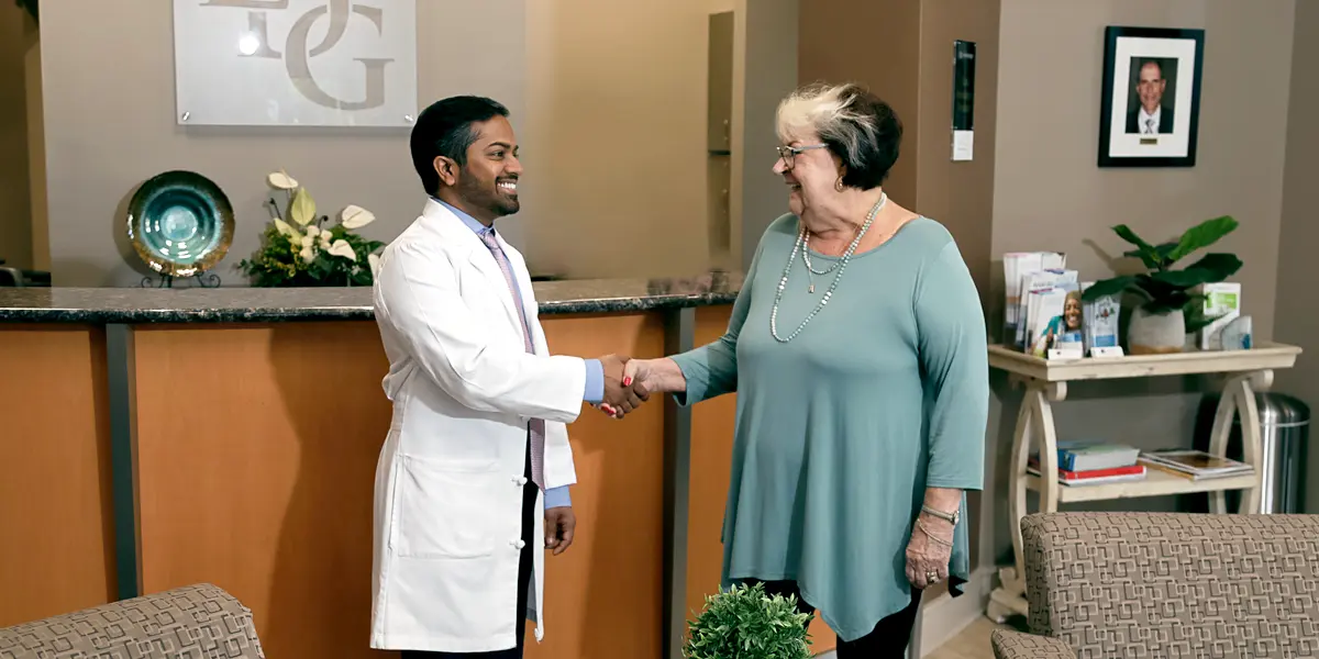 Image of Dr. Gupta greeting a patient.